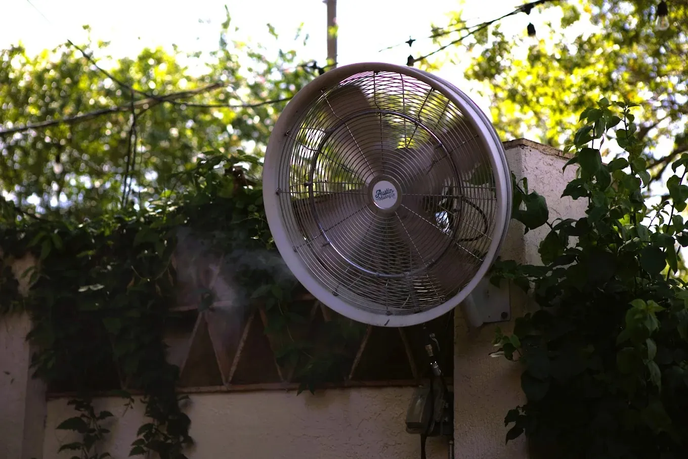 Austin Misting Company wall-mounted fan on a patio
