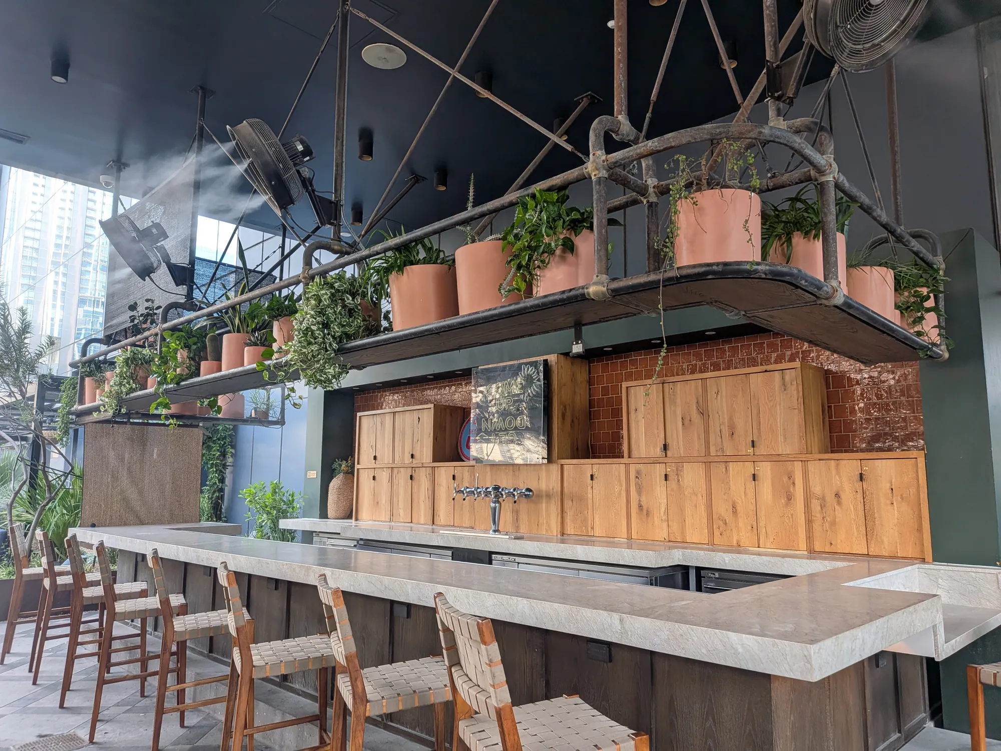 Commercial misting fans on a rooftop restaurant bar