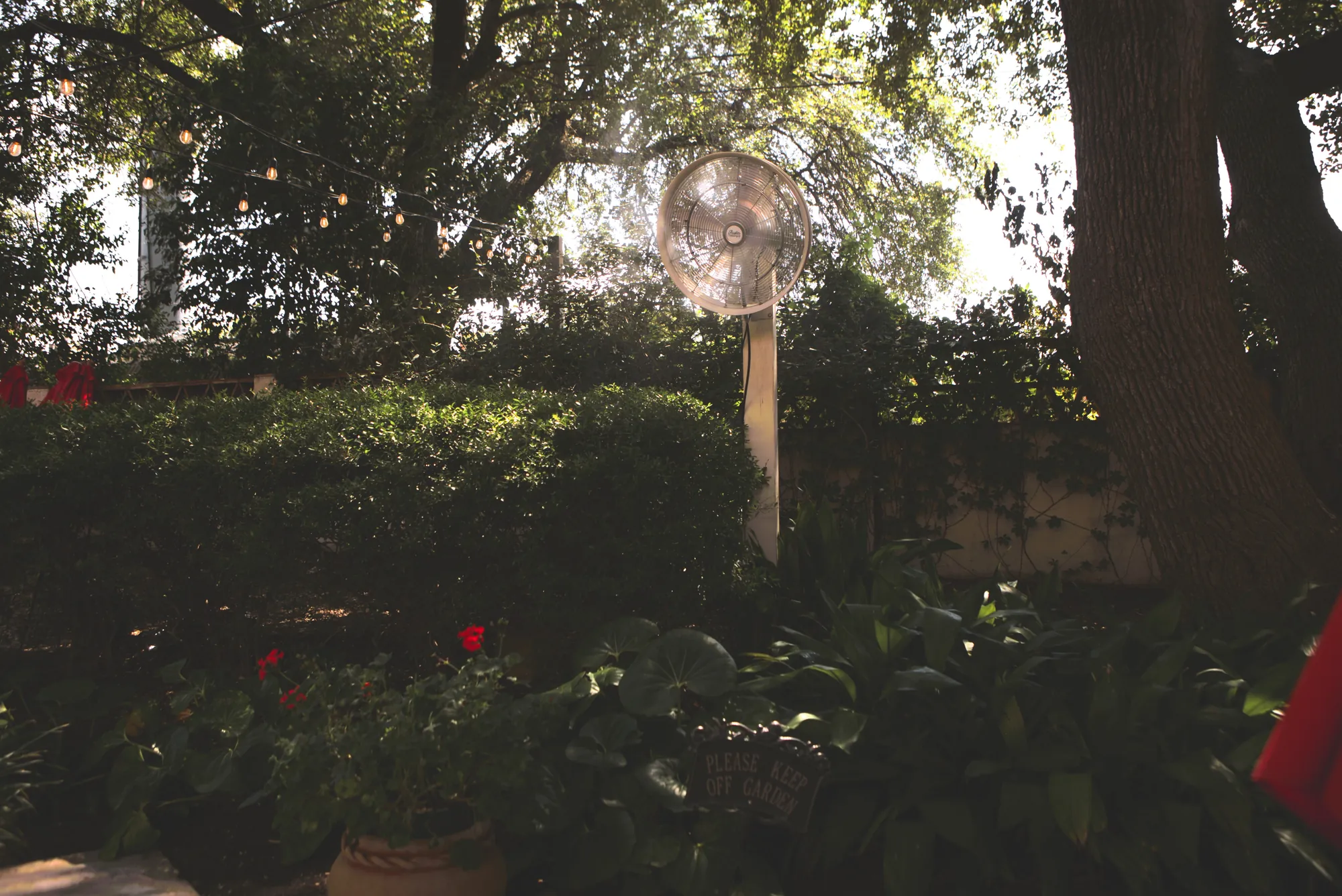 Post-mounted misting fan on a garden patio