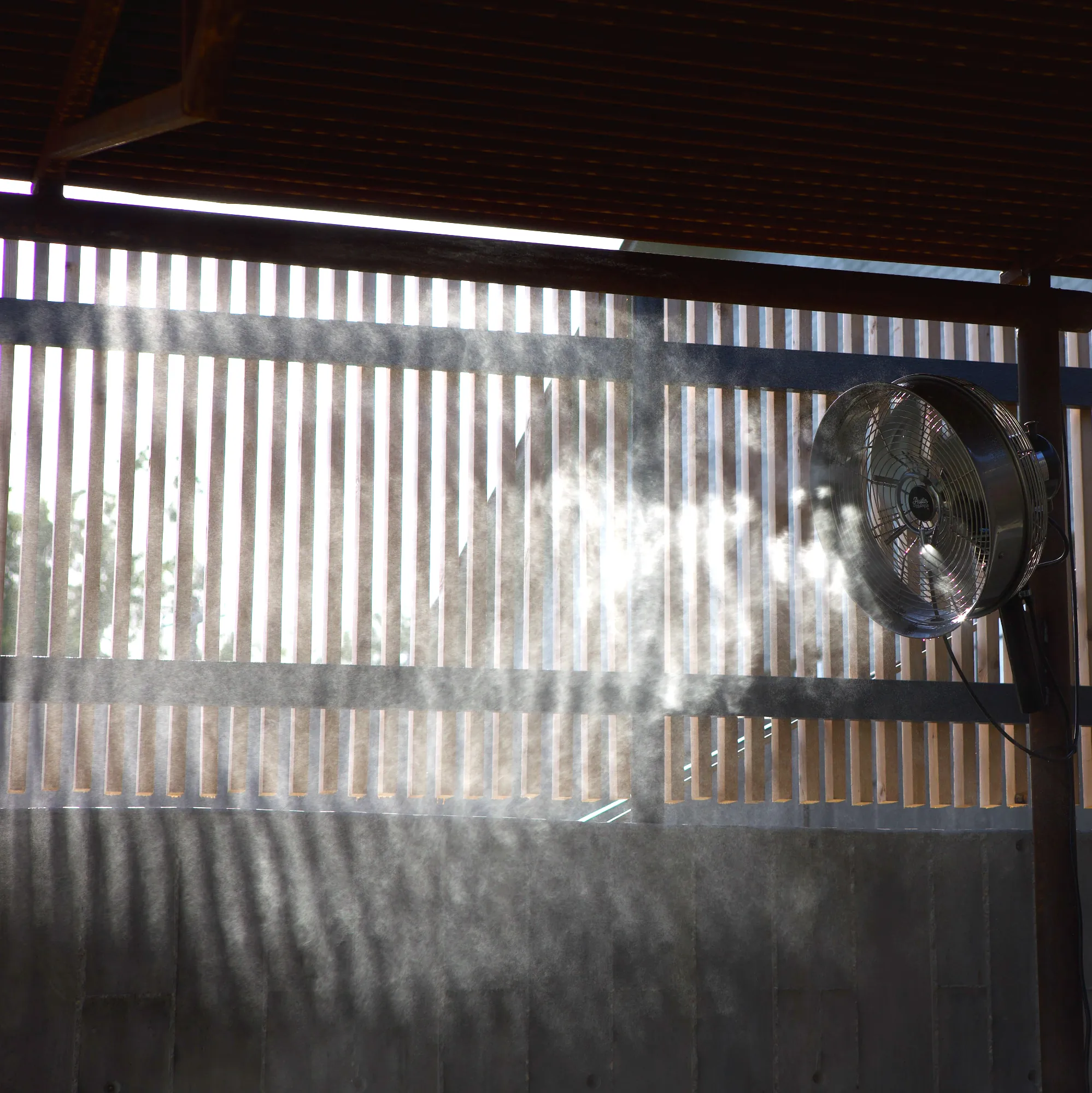 Backlit misting fan cooling a covered patio