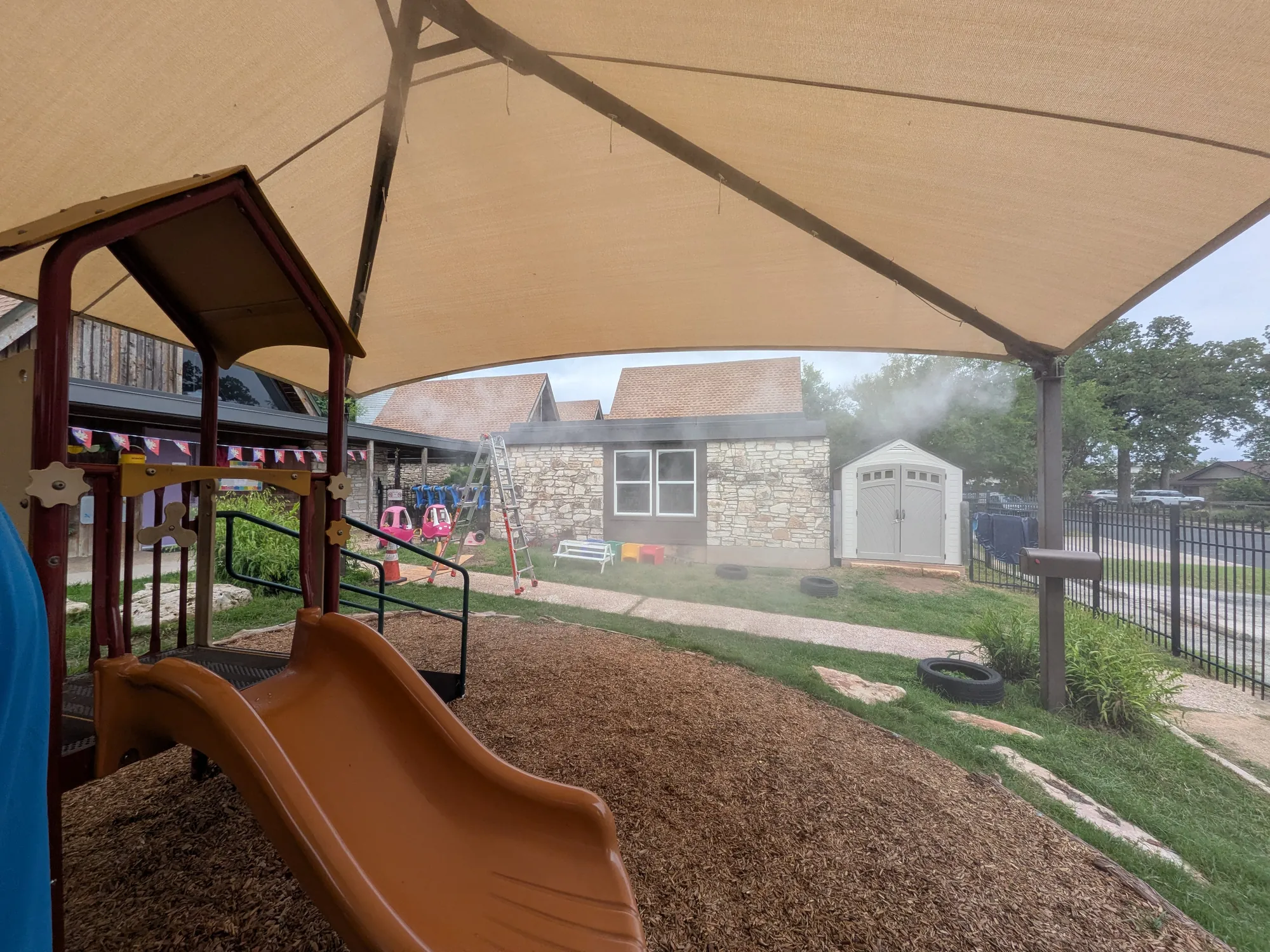 Playground misting system under a shade structure