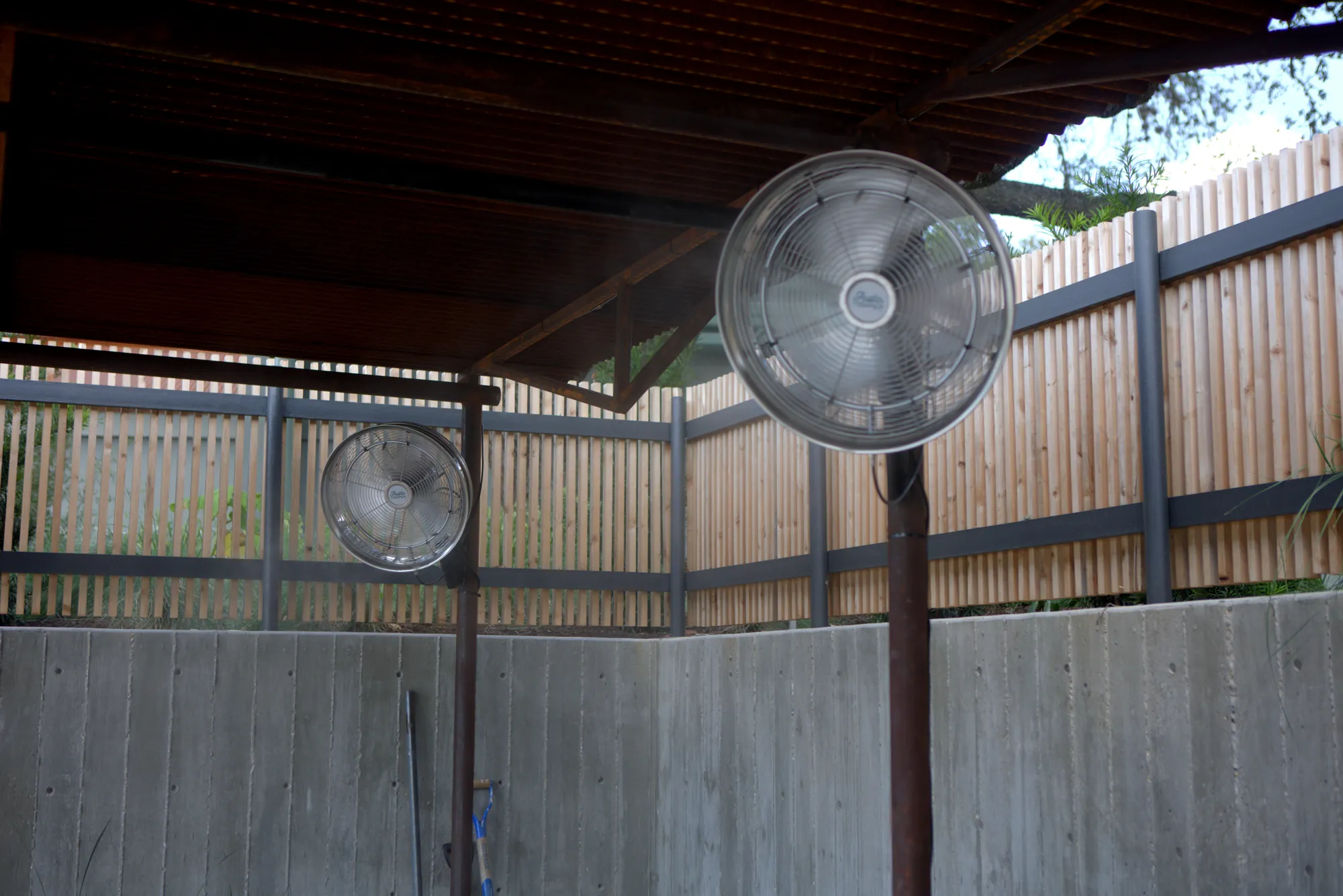 Post-mounted misting fans in an outdoor lounge