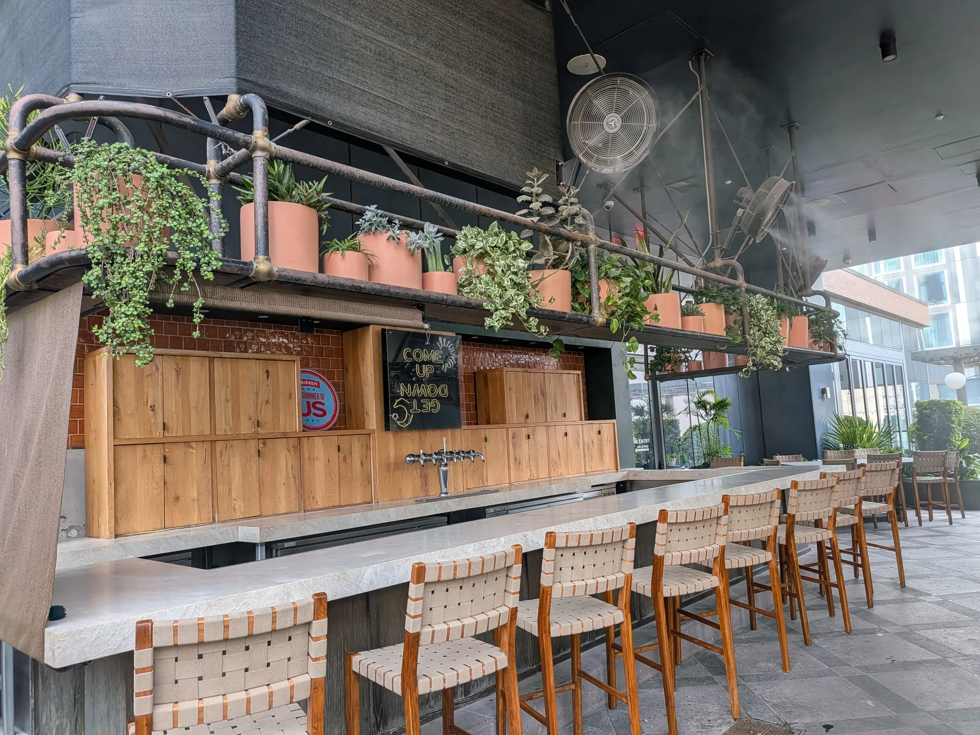 Rooftop bar misting fans overlooking downtown Austin