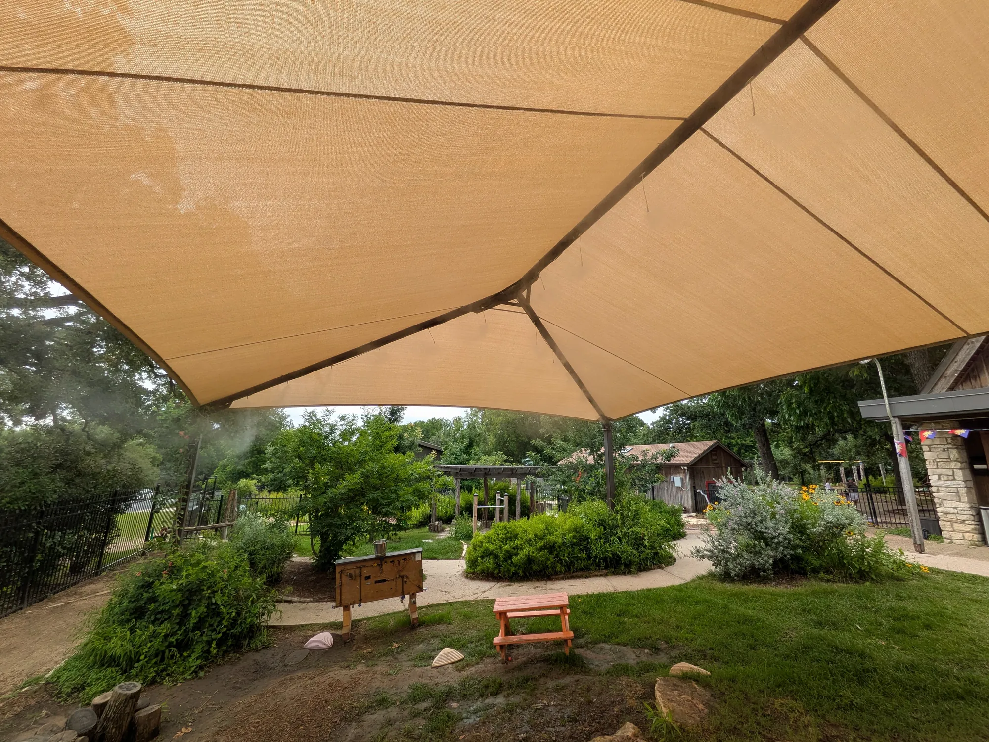 Shade canopy misting system over an outdoor play area