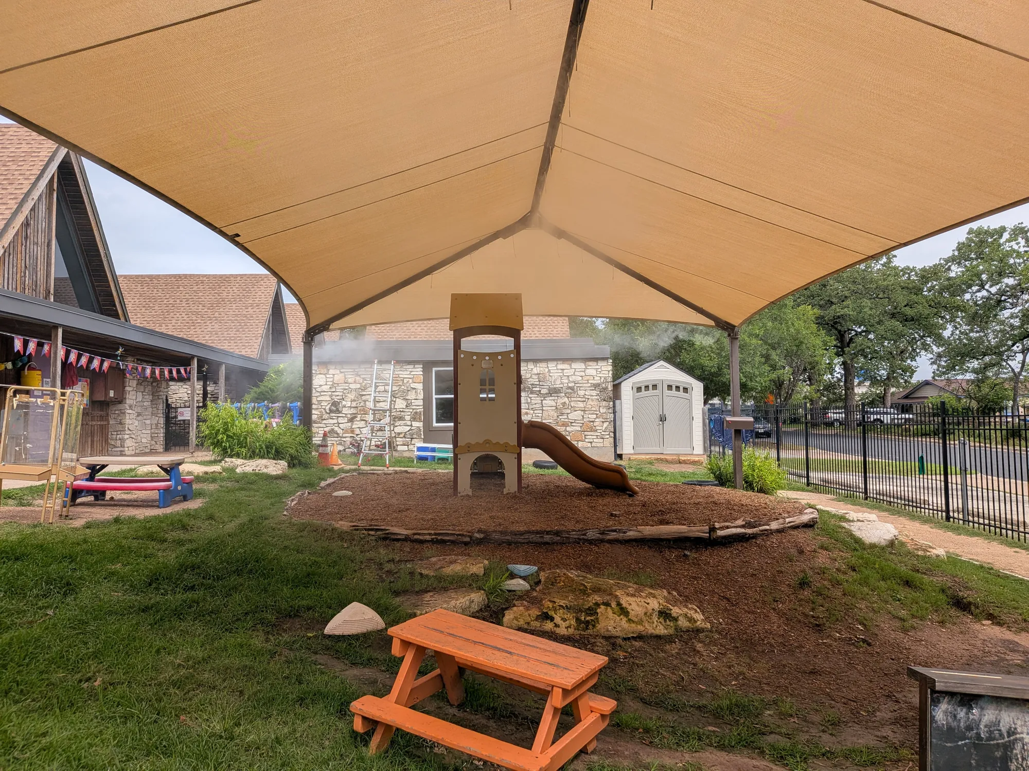 Shade sail misting system at an Austin playground