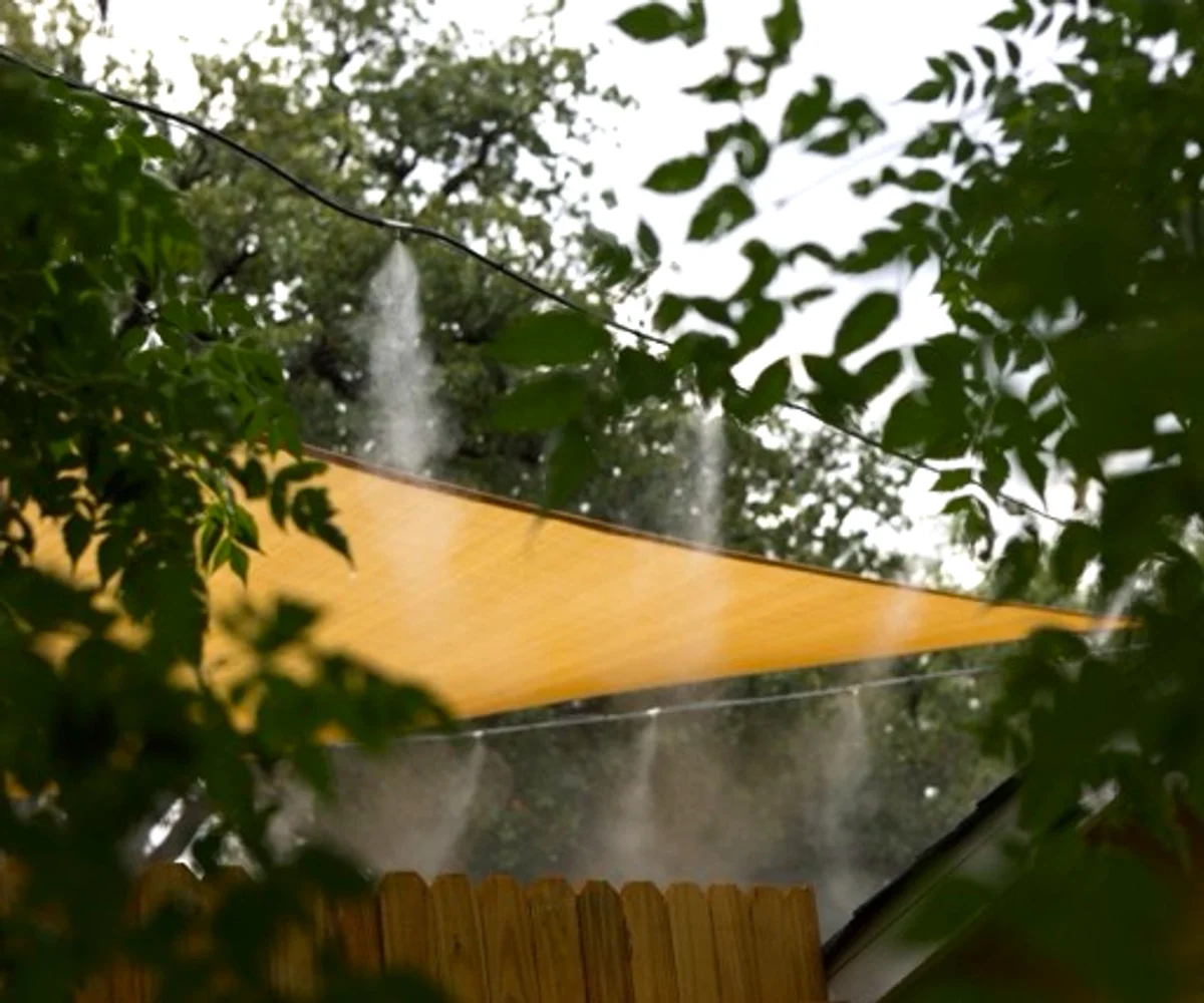 Sunshade with misting nozzles